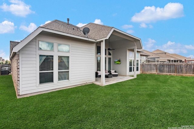 back of house with a yard, a patio, and ceiling fan