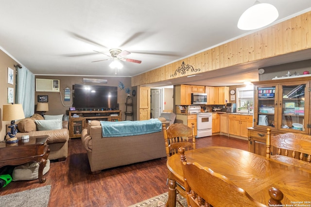 living room with ceiling fan, ornamental molding, and dark wood-type flooring