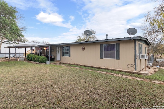 back of property with a lawn and cooling unit