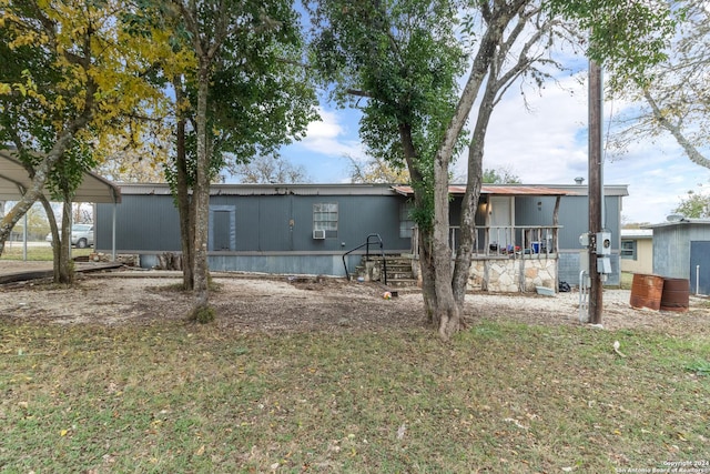 rear view of property with a lawn