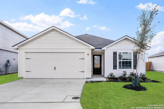 single story home with a front yard and a garage