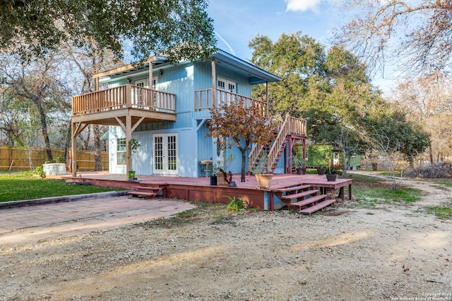 rear view of house with a deck and french doors