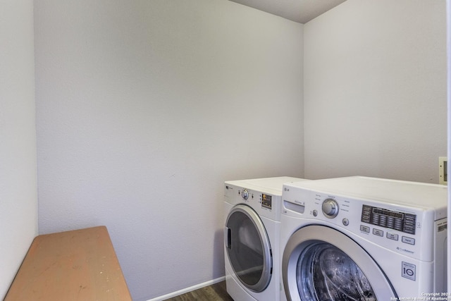 laundry room featuring dark hardwood / wood-style floors and washer and clothes dryer