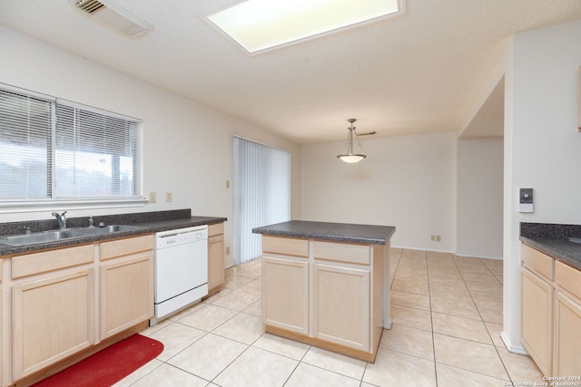 kitchen with dishwasher, sink, pendant lighting, light brown cabinetry, and light tile patterned floors