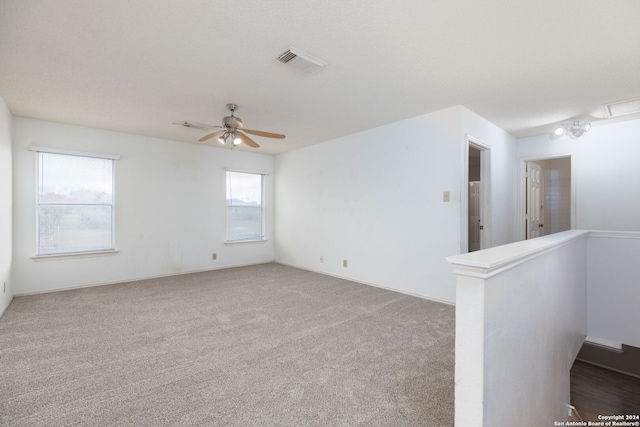 unfurnished room with carpet and ceiling fan