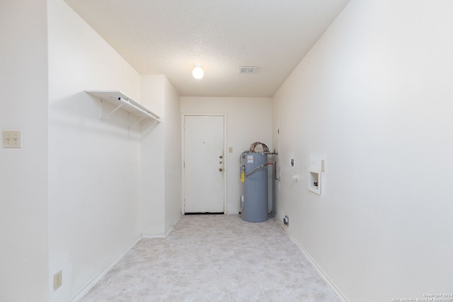 washroom with hookup for an electric dryer, electric water heater, hookup for a washing machine, a textured ceiling, and light carpet