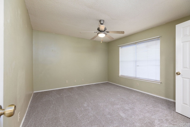 empty room featuring carpet flooring, ceiling fan, and a textured ceiling