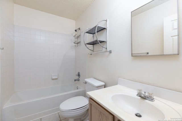 full bathroom featuring tile patterned floors, a textured ceiling, toilet, vanity, and tiled shower / bath