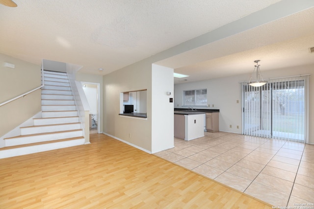 interior space with light hardwood / wood-style floors and a textured ceiling