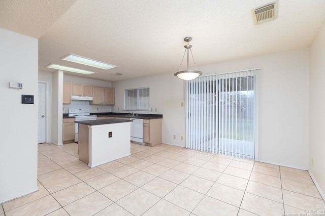 kitchen featuring a skylight, white appliances, a textured ceiling, decorative light fixtures, and a center island