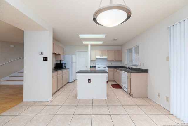 kitchen with sink, light brown cabinets, a textured ceiling, white appliances, and a kitchen island