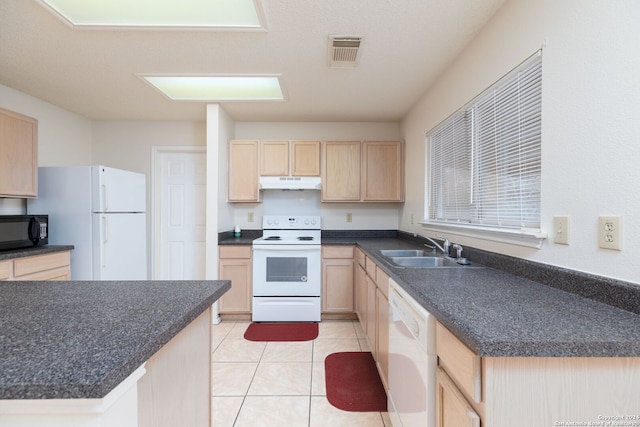 kitchen with light brown cabinets, white appliances, light tile patterned floors, and sink