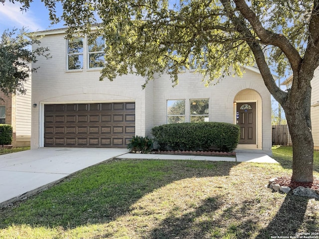 view of front of house with a front yard and a garage