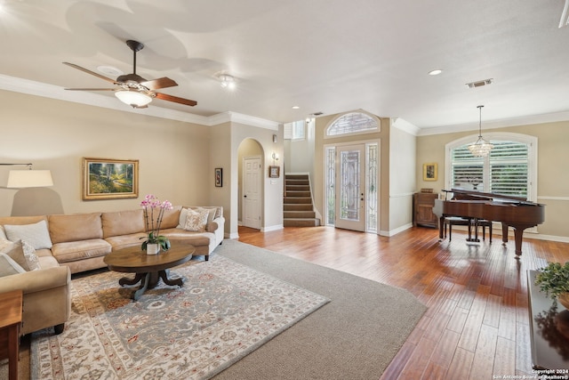 living room featuring ceiling fan, ornamental molding, and hardwood / wood-style floors