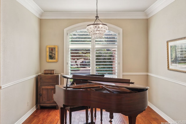 misc room with dark wood-type flooring, ornamental molding, and a chandelier