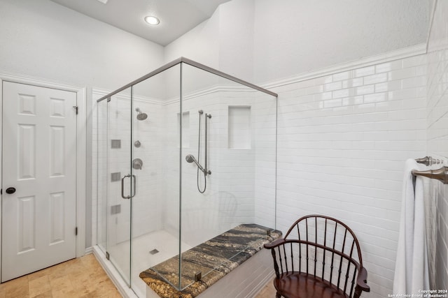 bathroom with a shower with door