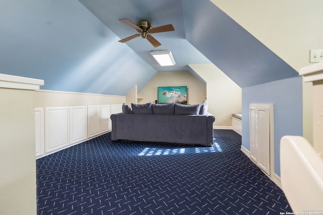 additional living space with dark carpet, vaulted ceiling, and ceiling fan