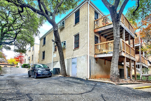 rear view of house featuring central AC unit