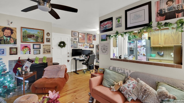 living room featuring ceiling fan and hardwood / wood-style flooring