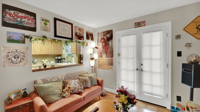 living room with light wood-type flooring and french doors