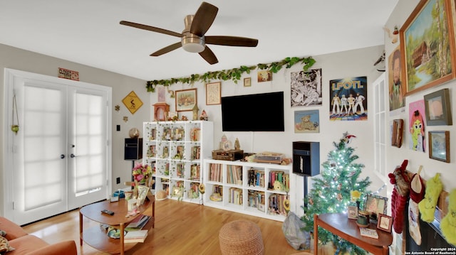 living room with french doors, light wood-type flooring, plenty of natural light, and ceiling fan