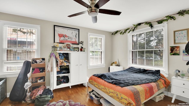 bedroom featuring hardwood / wood-style flooring and ceiling fan