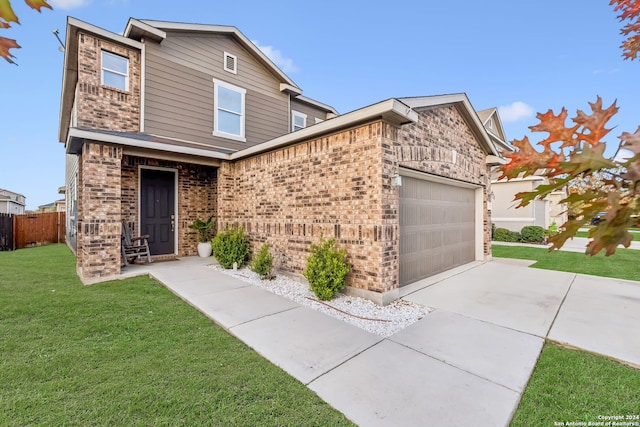 view of front of property featuring a front yard and a garage