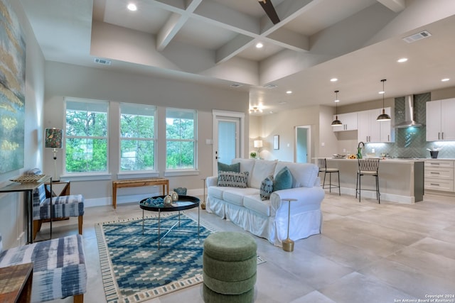 living room with beamed ceiling, a towering ceiling, and coffered ceiling