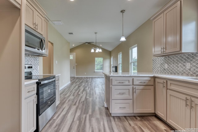 kitchen with decorative backsplash, decorative light fixtures, vaulted ceiling, and appliances with stainless steel finishes