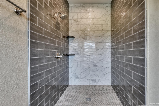 bathroom with tiled shower