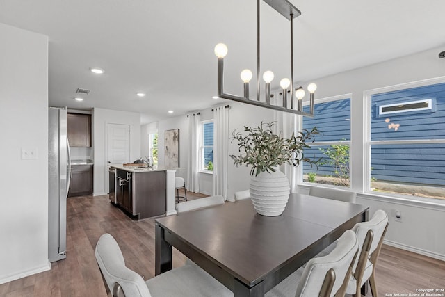 dining area featuring dark hardwood / wood-style flooring, a healthy amount of sunlight, and sink