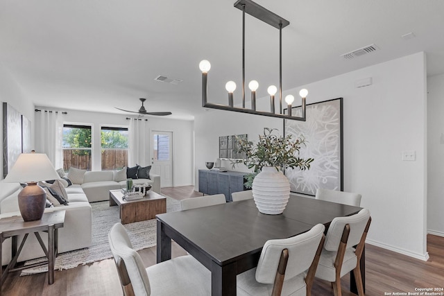 dining room with ceiling fan and dark wood-type flooring