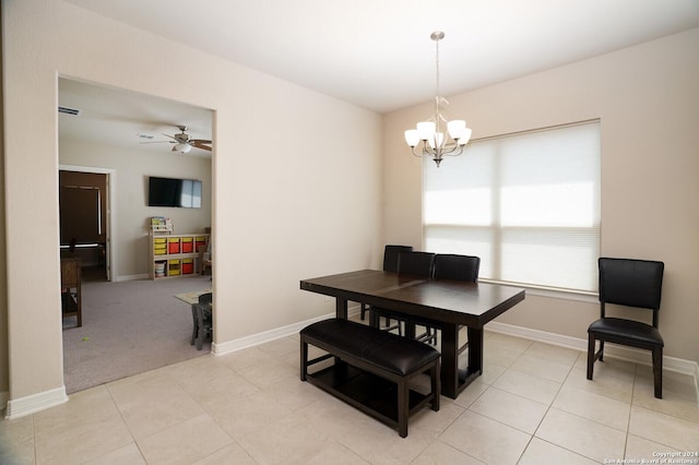 dining space with light carpet and ceiling fan with notable chandelier