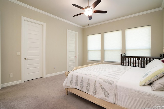 carpeted bedroom featuring ceiling fan and crown molding