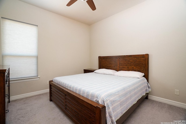 bedroom with ceiling fan and light carpet