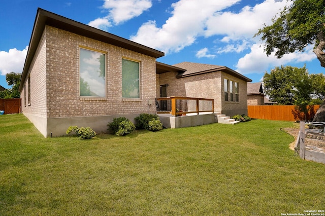 back of house featuring a yard