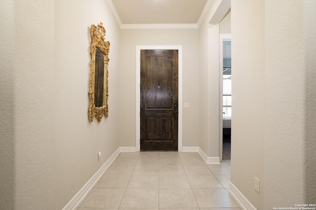 hall featuring crown molding and light tile patterned floors