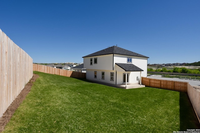 rear view of property with a patio area and a lawn