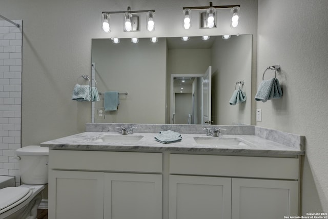 bathroom featuring vanity and toilet