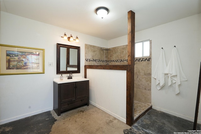 bathroom with vanity, concrete flooring, and tiled shower