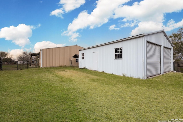 exterior space with a garage and a lawn