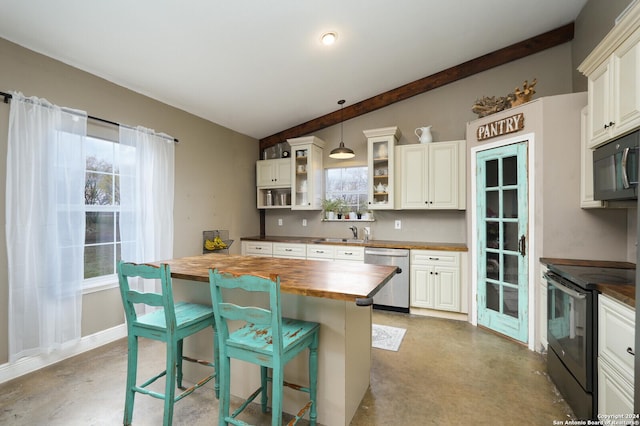 kitchen with black appliances, plenty of natural light, pendant lighting, and butcher block counters