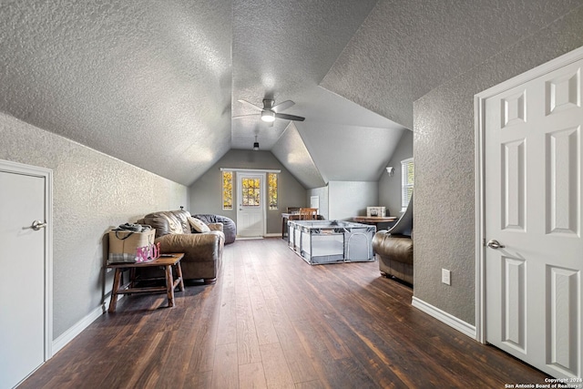 bedroom with a textured ceiling, multiple windows, dark hardwood / wood-style flooring, and lofted ceiling