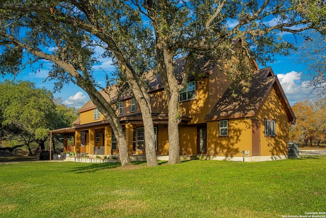 back of house with a yard and covered porch