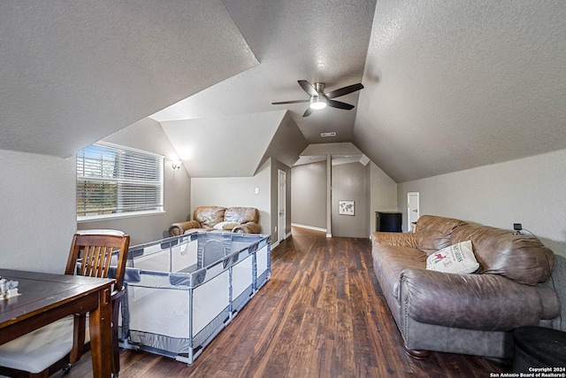 interior space with a textured ceiling, dark hardwood / wood-style flooring, vaulted ceiling, and ceiling fan