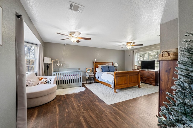 bedroom featuring ceiling fan, a textured ceiling, and hardwood / wood-style flooring