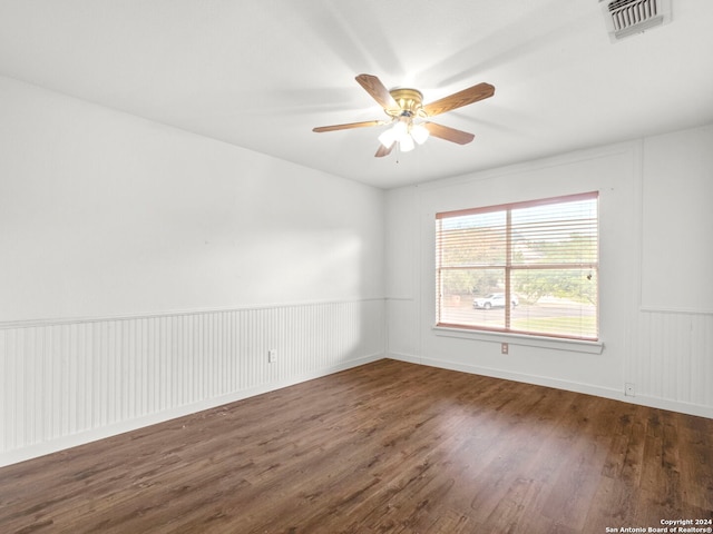 empty room with ceiling fan and dark wood-type flooring