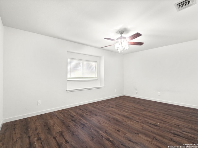 empty room with ceiling fan and dark hardwood / wood-style floors