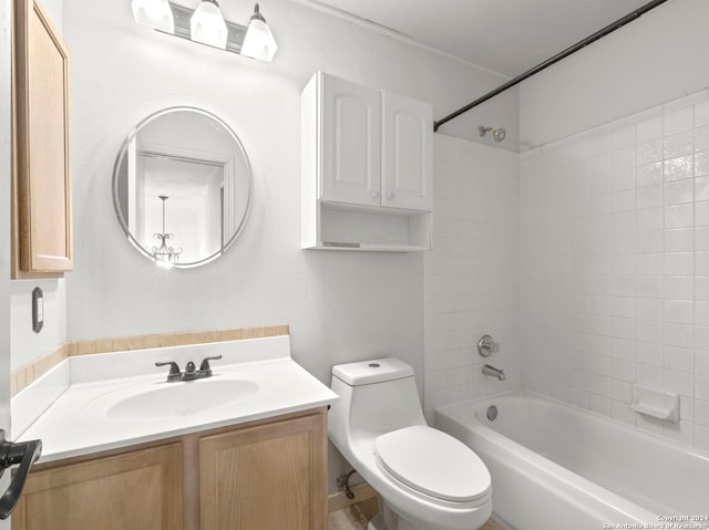 full bathroom featuring vanity, tiled shower / bath combo, and toilet