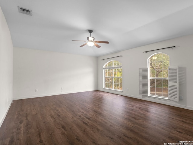 spare room with dark hardwood / wood-style floors and ceiling fan